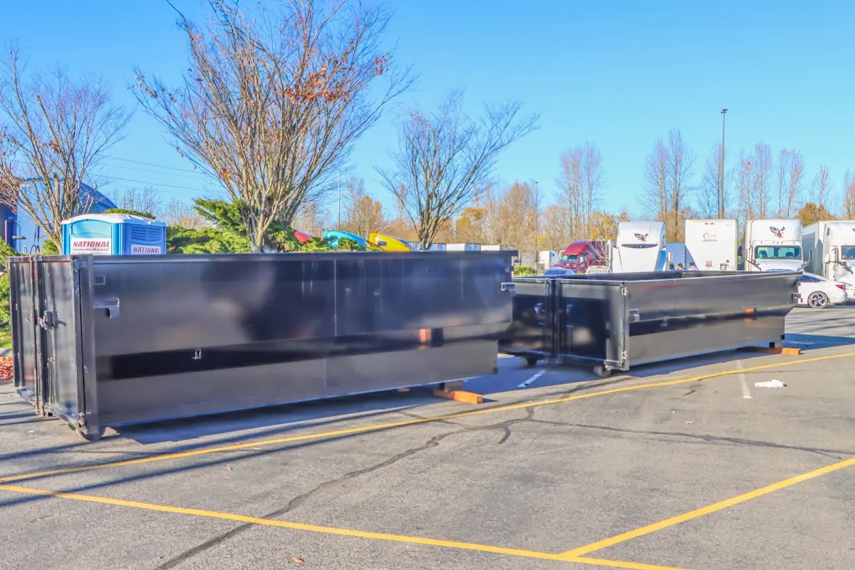 Professional dumpster rental service with roll-off container on residential driveway in Milton